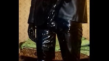 Guy in latex mask and latex shorts, vinyl pants and gloves