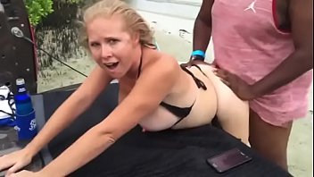 Mature on the beach while husband films