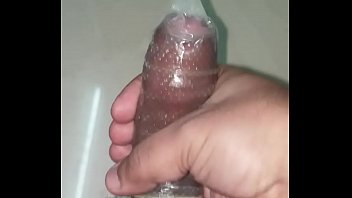 Indian man cums in a dotted condom