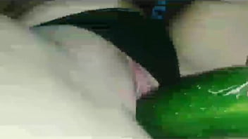 Hot young girl inserts a cucumber