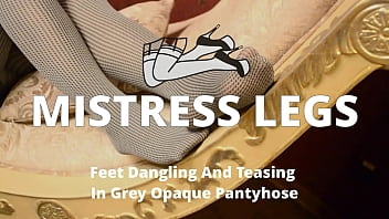 Feet dangling and teasing in grey opaque pantyhose