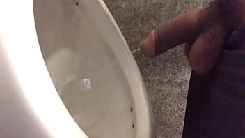 Young guy I shake pissing without his hand in the nightclub's bathroom