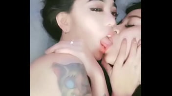Two girls kiss each other's nipples