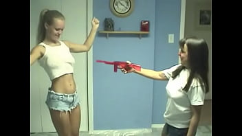 Lesbians sticks water gun nozzle in their cunts on floor