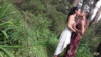 Outdoor interracial lesbian sex in a forest between a skinny ebony chick and a brunette with big tits