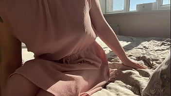 in a delicate pink dress plays with her holes
