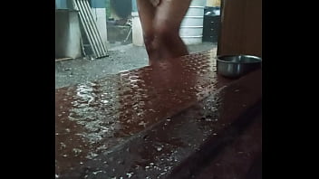 Indian boy bathing in rain
