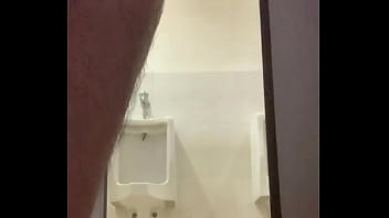 Jerking off in a public toilet